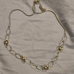 Chicos goldtone link necklace. Featuring oval links and beaded stations.